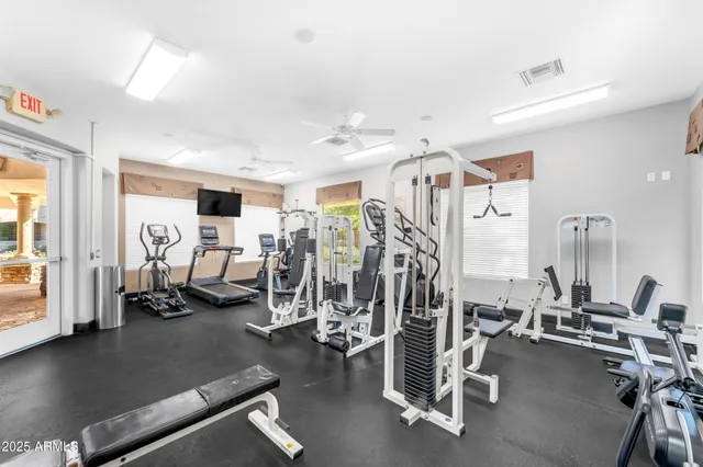 a view of a dining room and livingroom with furniture wooden floor a rug and a chandelier
