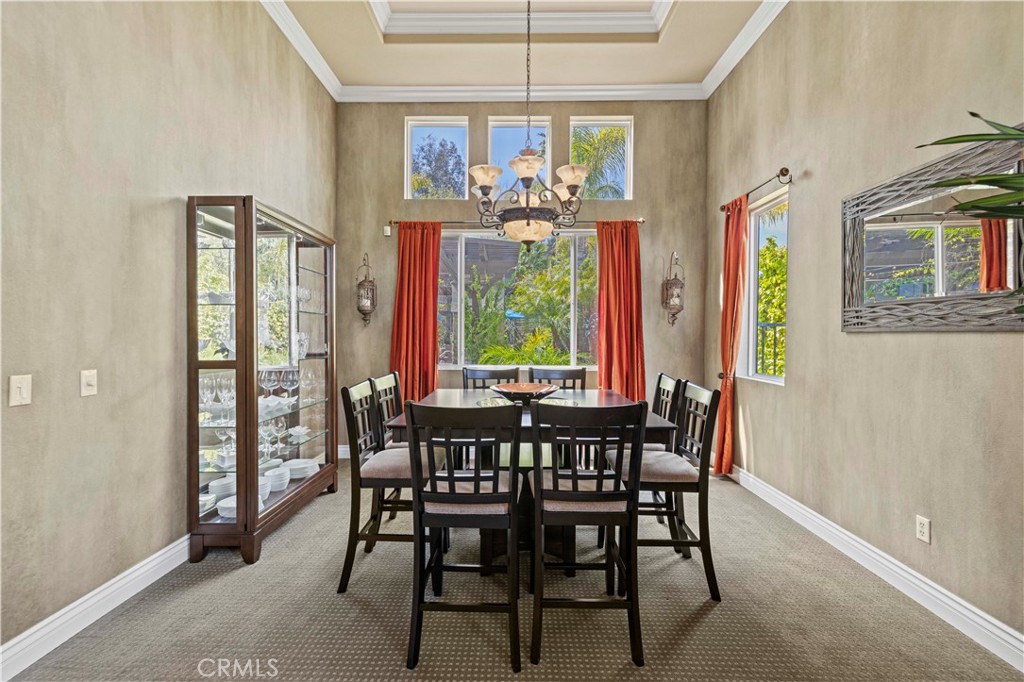 25221 Summerhill Lane Stevenson Ranch, CA 91381 - Photo 11 of 74 a view of a dining room with furniture a chandelier and wooden floor