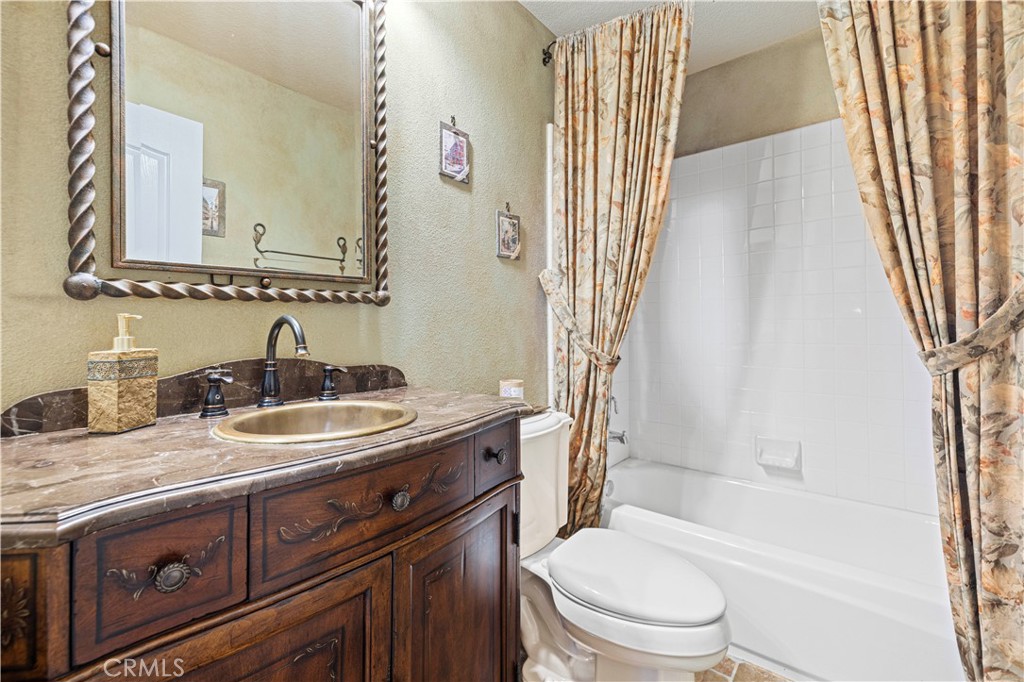 25221 Summerhill Lane Stevenson Ranch, CA 91381 - Photo 13 of 74 a bathroom with a granite countertop sink toilet and shower