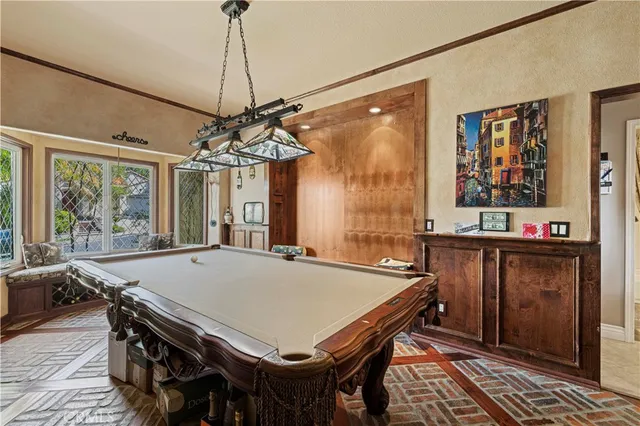 a kitchen with stainless steel appliances granite countertop a table chairs and refrigerator