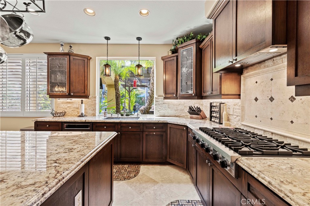25221 Summerhill Lane Stevenson Ranch, CA 91381 - Photo 22 of 74 a kitchen with stainless steel appliances granite countertop a stove a sink and a microwave