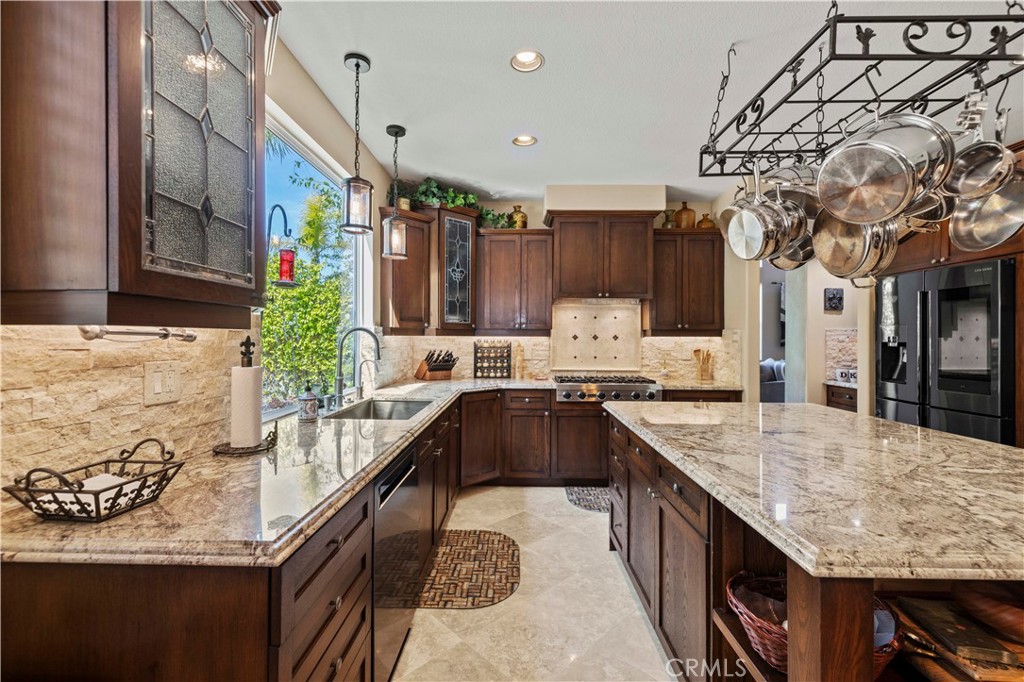 25221 Summerhill Lane Stevenson Ranch, CA 91381 - Photo 23 of 74 a kitchen with granite countertop lots of counter top space and wooden floor