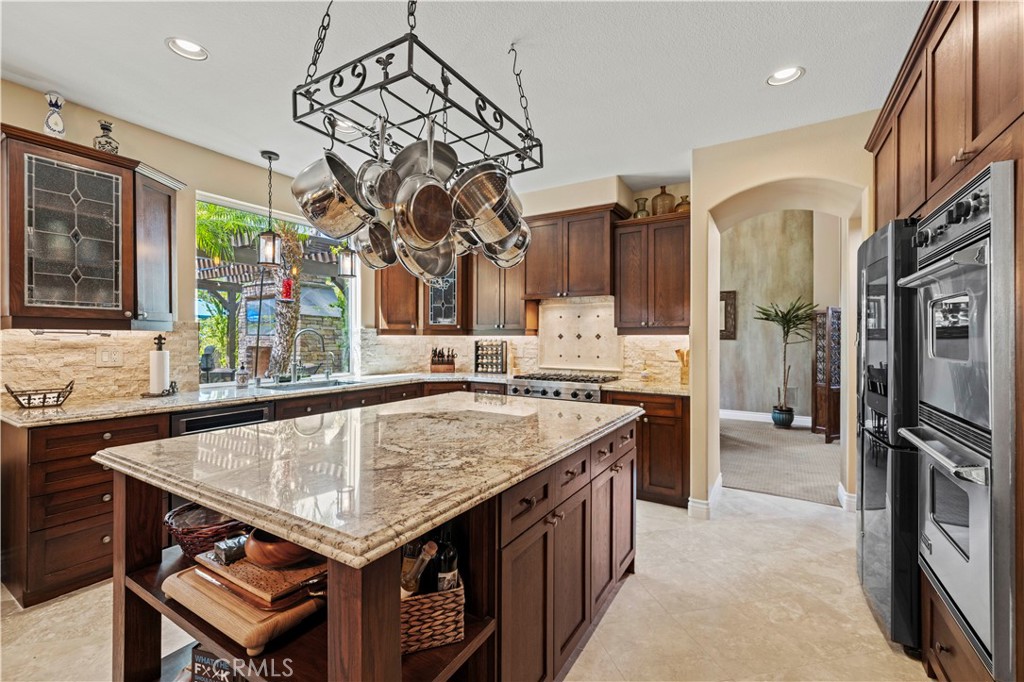 25221 Summerhill Lane Stevenson Ranch, CA 91381 - Photo 24 of 74 a kitchen with a stove a sink dishwasher and a refrigerator with wooden floor