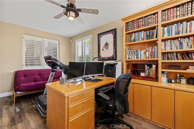 a bed room with a bed a dresser and a chandelier