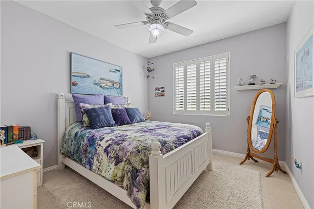 a spacious bedroom with a bed and a chandelier
