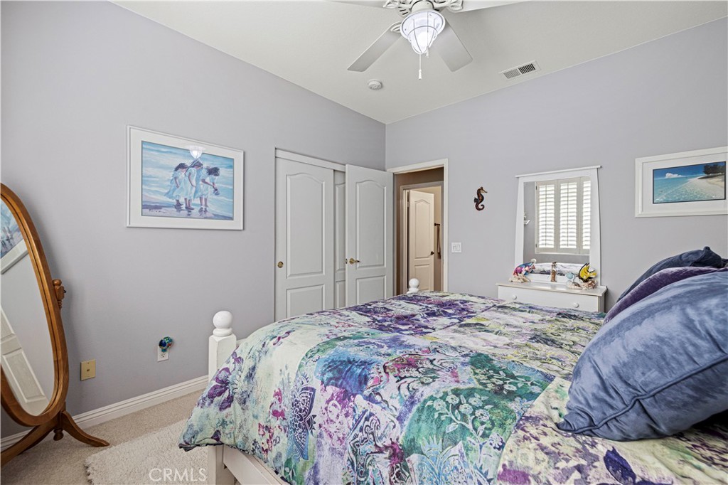 25221 Summerhill Lane Stevenson Ranch, CA 91381 - Photo 35 of 74 a bedroom with a large bed and a chandelier