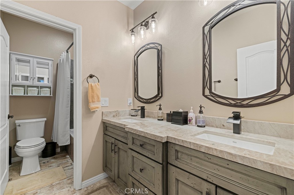 25221 Summerhill Lane Stevenson Ranch, CA 91381 - Photo 36 of 74 a bathroom with a double vanity sink and a mirror