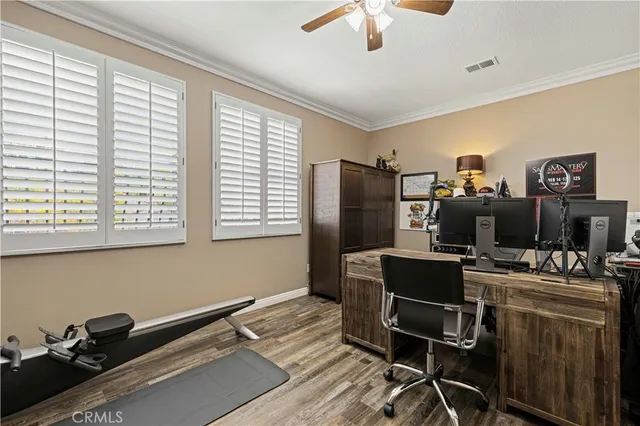 a view of a patio with table and chairs potted plants and large tree
