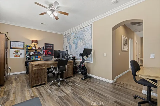 a view of a patio with table and chairs under an umbrella with large trees