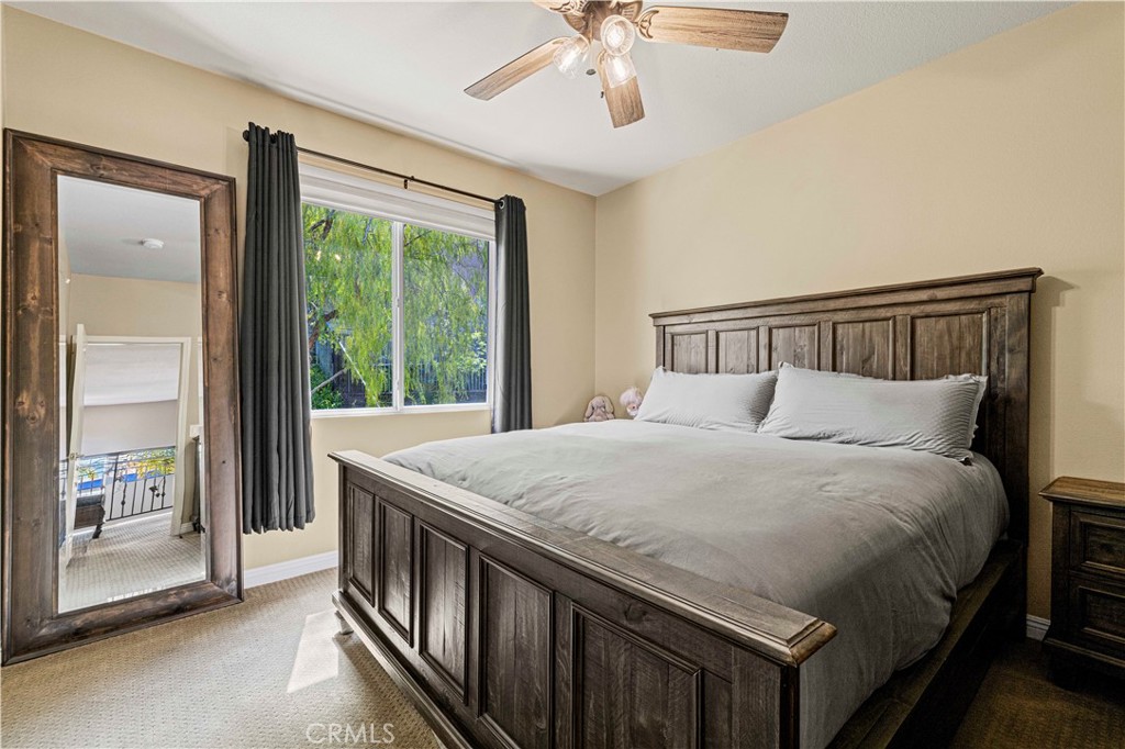 25221 Summerhill Lane Stevenson Ranch, CA 91381 - Photo 42 of 74 a bed sitting in a bedroom next to a balcony