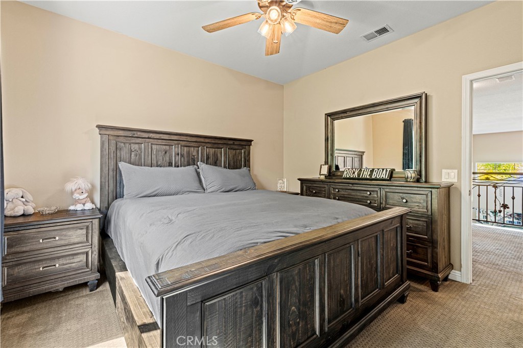 25221 Summerhill Lane Stevenson Ranch, CA 91381 - Photo 43 of 74 a bedroom with a bed and a chandelier