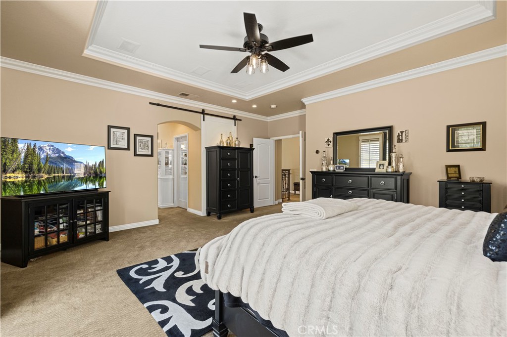 25221 Summerhill Lane Stevenson Ranch, CA 91381 - Photo 45 of 74 a bed room with a bed a dresser and a chandelier