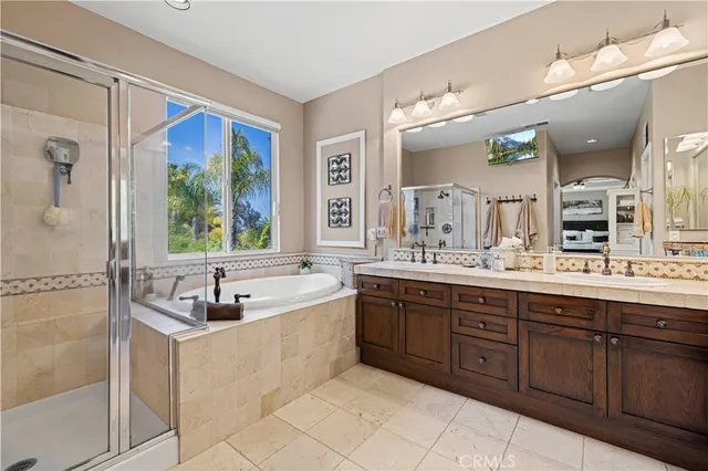 a front view of a house with a yard and potted plants