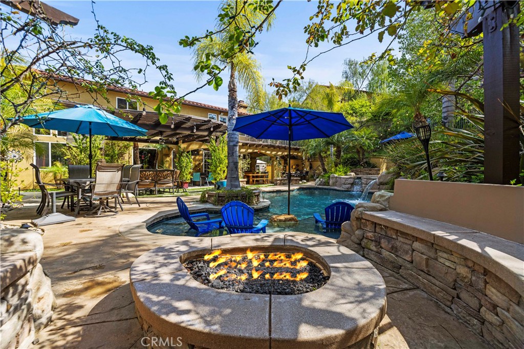 25221 Summerhill Lane Stevenson Ranch, CA 91381 - Photo 57 of 74 a view of a patio with swimming pool table and chairs