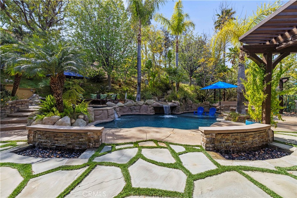 25221 Summerhill Lane Stevenson Ranch, CA 91381 - Photo 59 of 74 a view of a patio with table and chairs potted plants and large tree