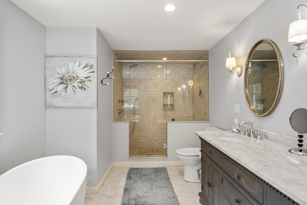 30 Franklin Rodgers Road Hingham, MA 02043 - Photo 27 of 37 a spacious bathroom with a granite countertop sink toilet a mirror and a shower