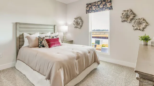 a bedroom with a bed and a mirror on dresser