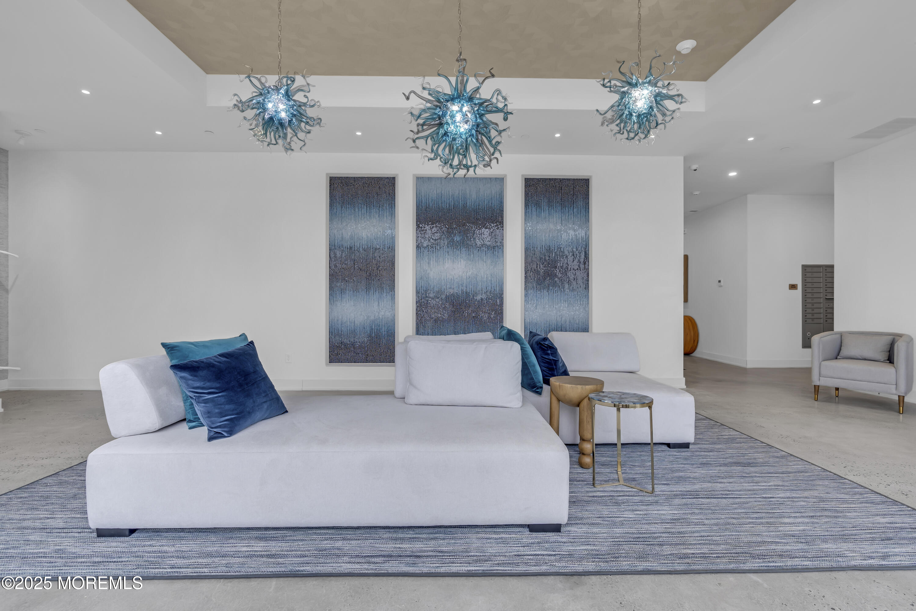 a large bed sitting in a room next to a chandelier