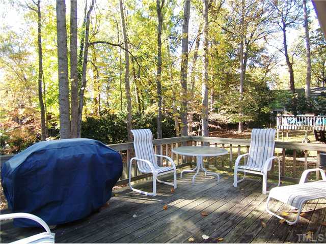 908 Hemingway Drive Raleigh, NC 27609 - Photo 21 of 25 The spacious Deck overlooks the level, .32 acre wooded lot w/wooded & fenced backyard.