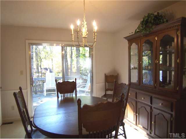 908 Hemingway Drive Raleigh, NC 27609 - Photo 4 of 25 The bright Dining Rm offers panel wainscot & chair rail and sliders to the Deck for easy entertaining.