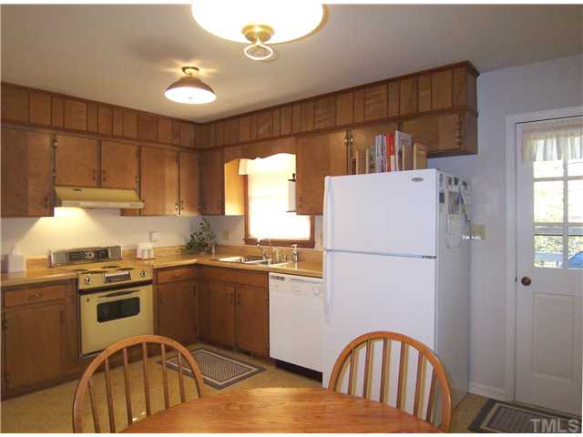 908 Hemingway Drive Raleigh, NC 27609 - Photo 6 of 25 The spacious eat-in Kitchen has lots of wood cabinets, neutral vinyl flooring, electric self-clean range, range hood, dishwasher, disposal and door to the Deck, so grilling is a breeze!