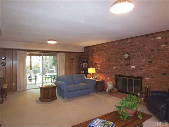 908 Hemingway Drive Raleigh, NC 27609 - Photo 8 of 25 The huge Family Rm offers a full brick wall, brick FP, lg picture window and sliders to the Patio & backyard!
