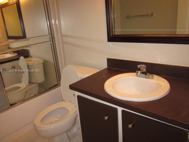 11350 Southwest 68th Terrace Miami, FL 33173 - Photo 12 of 31 a bathroom with a sink and a mirror