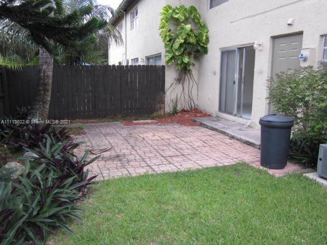 11350 Southwest 68th Terrace Miami, FL 33173 - Photo 15 of 31 a view of a backyard with potted plants and a wooden fence