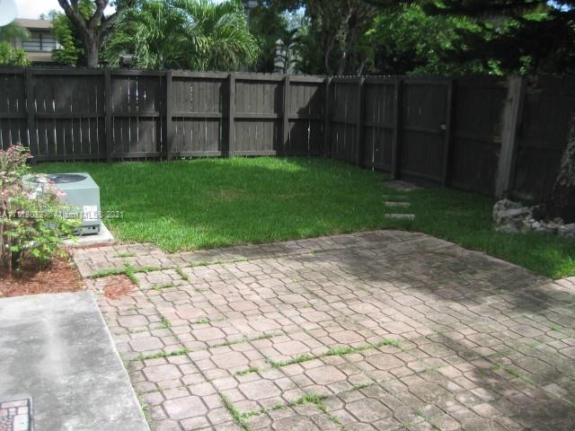 11350 Southwest 68th Terrace Miami, FL 33173 - Photo 17 of 31 a view of a backyard with a potted plants and covered with wooden fence