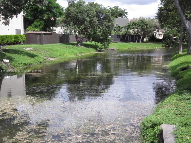 11350 Southwest 68th Terrace Miami, FL 33173 - Photo 31 of 31 a view of a lake with a house in the background