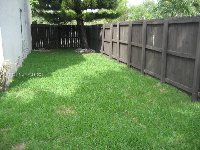 11350 Southwest 68th Terrace Miami, FL 33173 - Photo 5 of 31 a view of a backyard with a wooden fence