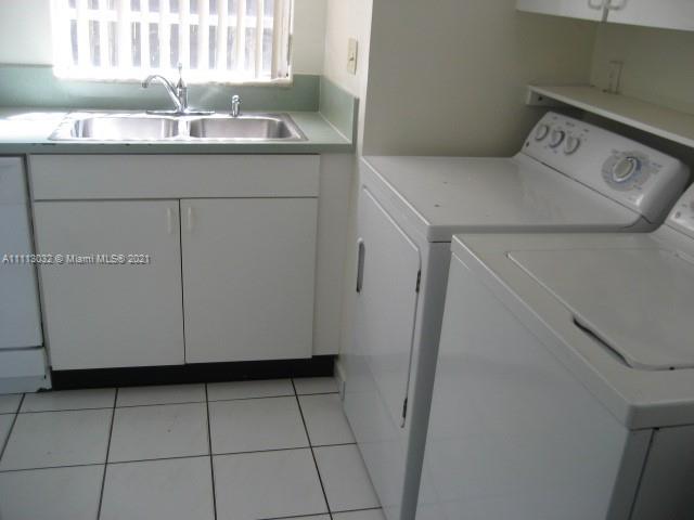 11350 Southwest 68th Terrace Miami, FL 33173 - Photo 9 of 31 a kitchen with a sink a stove and cabinets
