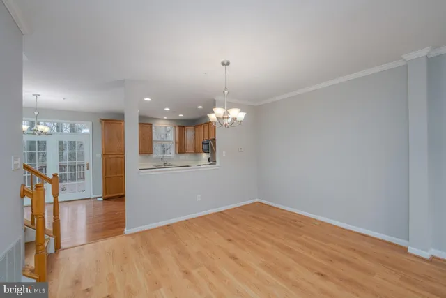 a view of a room with wooden floor and windows