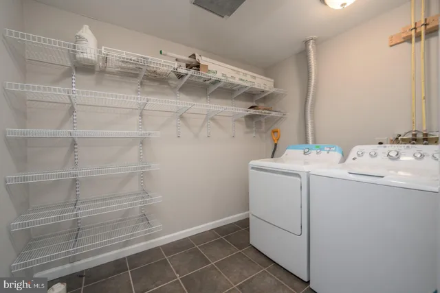 a utility room with cabinets washer and dryer