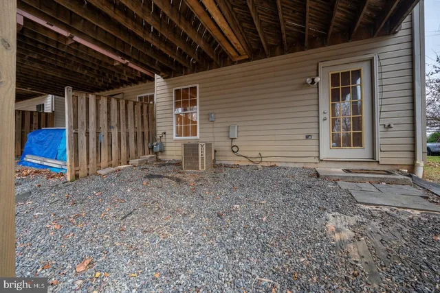 a view of house with backyard and tub
