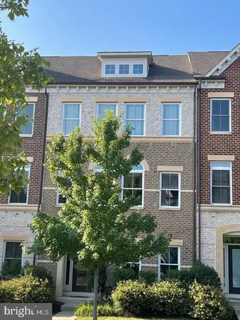 front view of a house with a tree