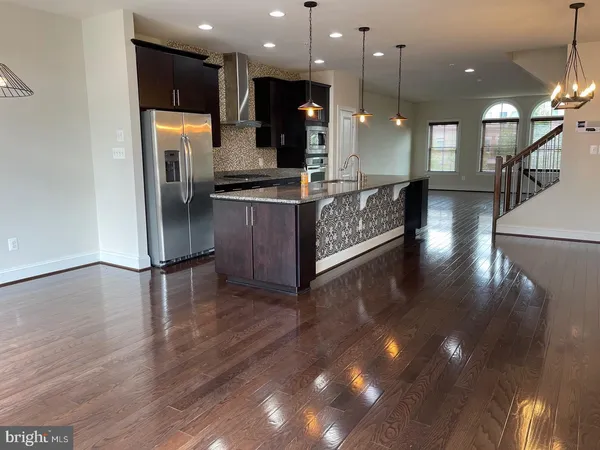 a kitchen with stainless steel appliances granite countertop a refrigerator and a stove