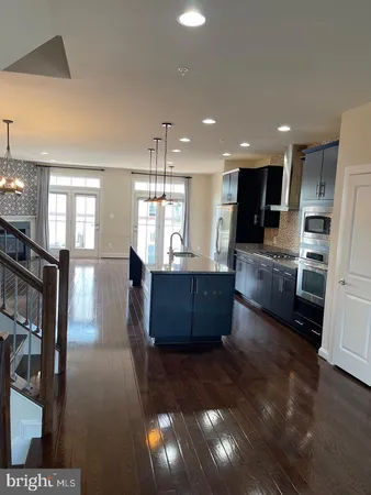 a large kitchen with a large counter top appliances and cabinets