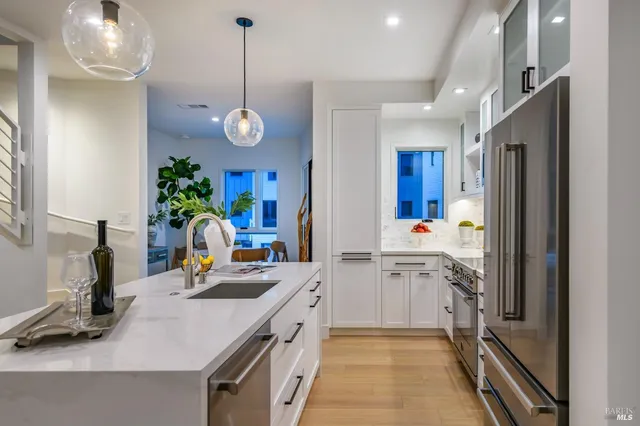 a kitchen with a sink refrigerator and cabinets