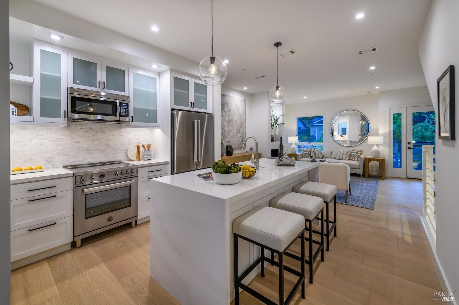 1112 Foster Road Napa, CA 94558 - Photo 12 of 26 a kitchen with stainless steel appliances kitchen island granite countertop a sink and a refrigerator