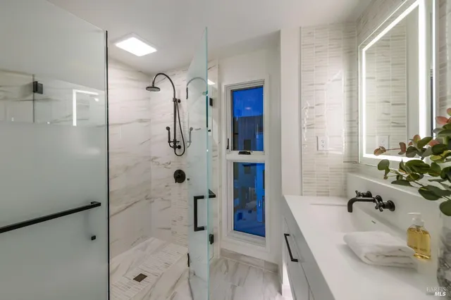 a bathroom with a tub sink and shower