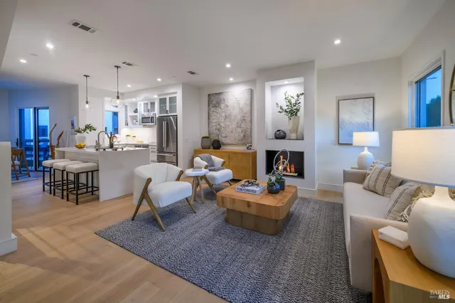 a living room with fireplace furniture and a wooden floor