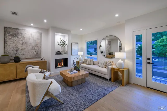 a living room with furniture and a fireplace