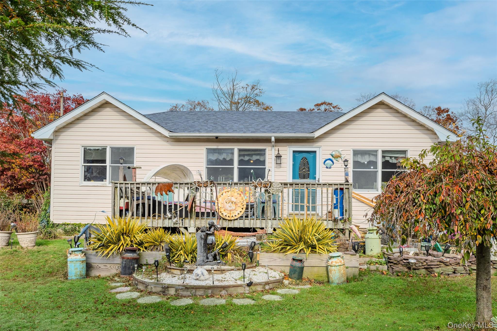 a front view of a house with a garden and patio