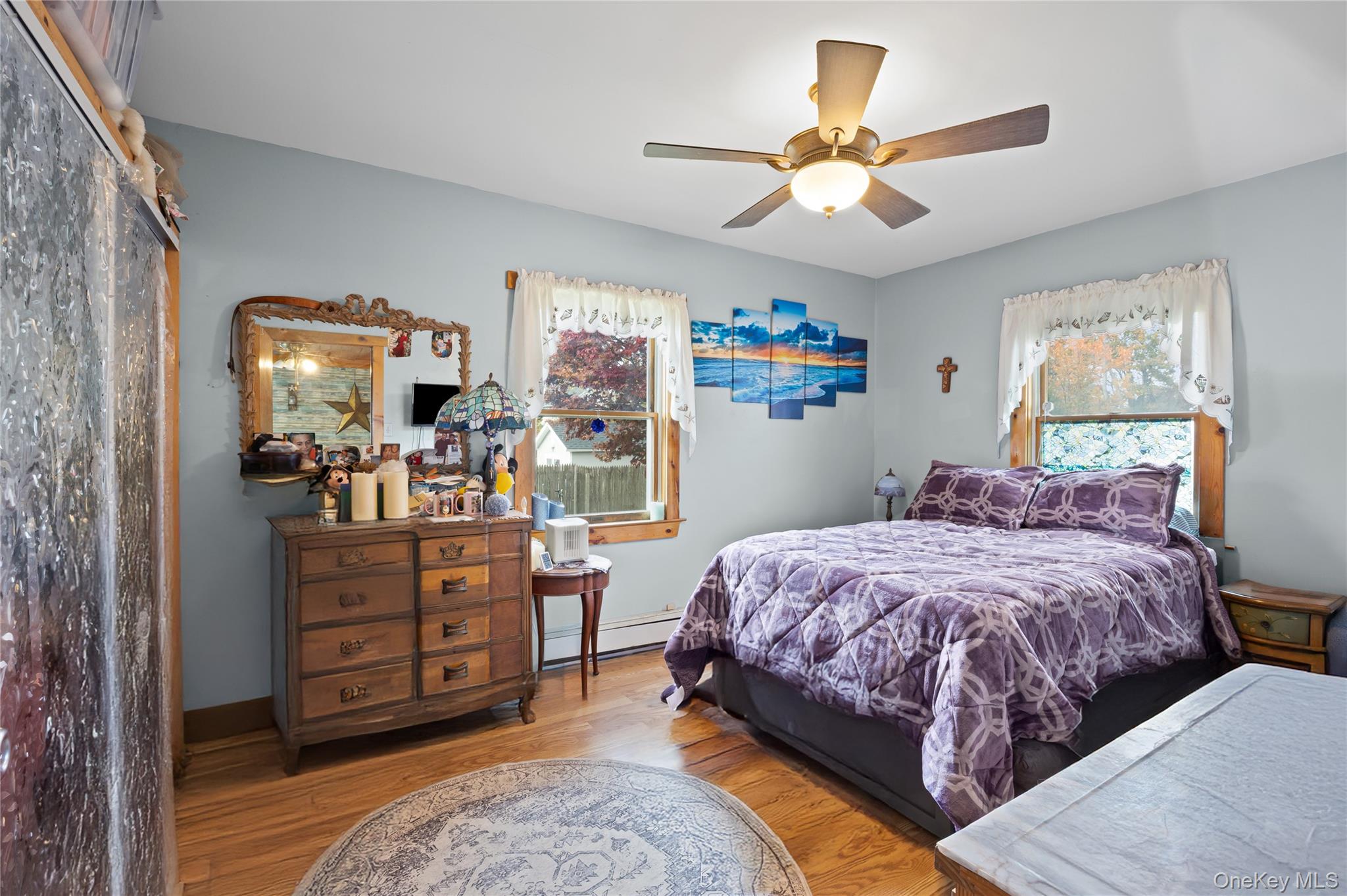 1 Elm Road East Mastic Beach, NY 11951 - Photo 14 of 28 a bedroom with a bed and a chandelier