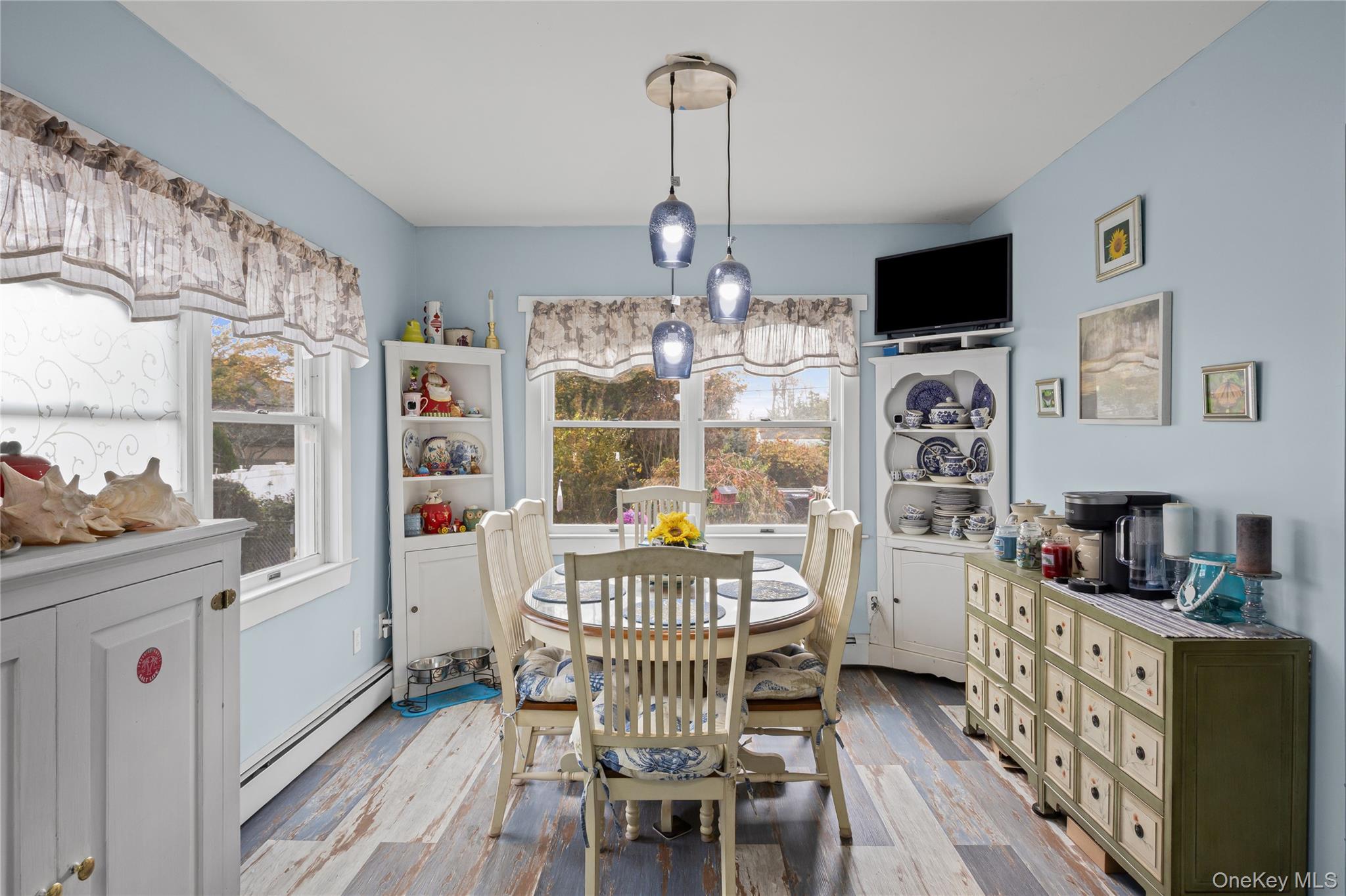 1 Elm Road East Mastic Beach, NY 11951 - Photo 15 of 28 a dining room with furniture and wooden floor