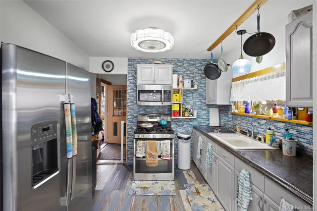 a kitchen with stainless steel appliances kitchen island granite countertop a sink and cabinets