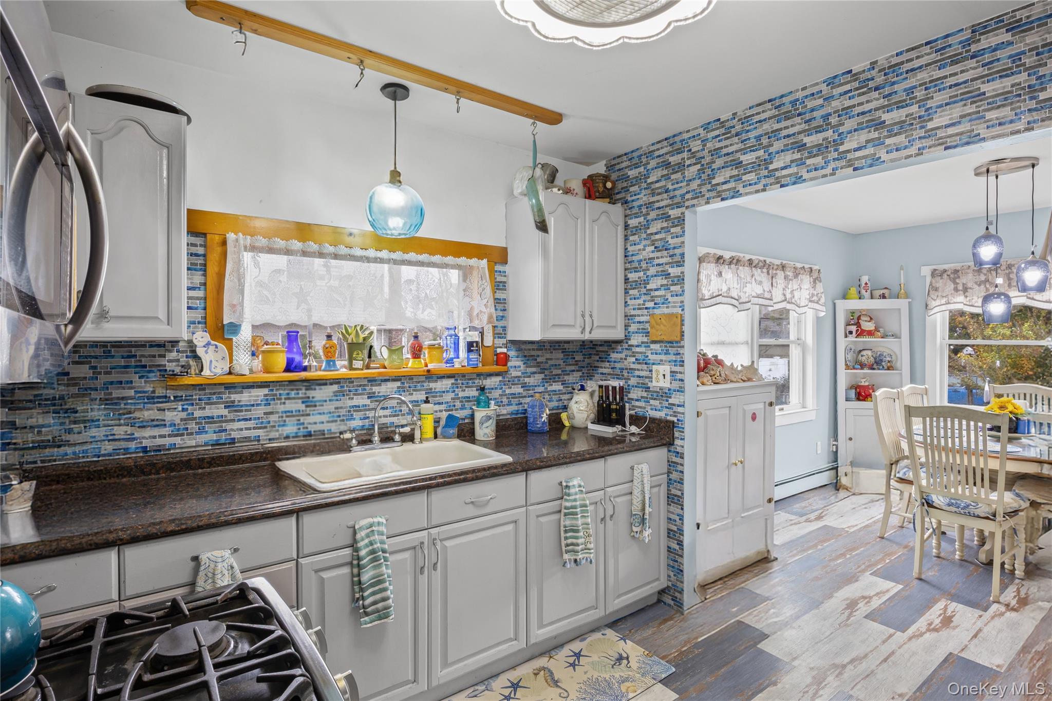1 Elm Road East Mastic Beach, NY 11951 - Photo 18 of 28 a kitchen with stainless steel appliances kitchen island granite countertop a sink and cabinets