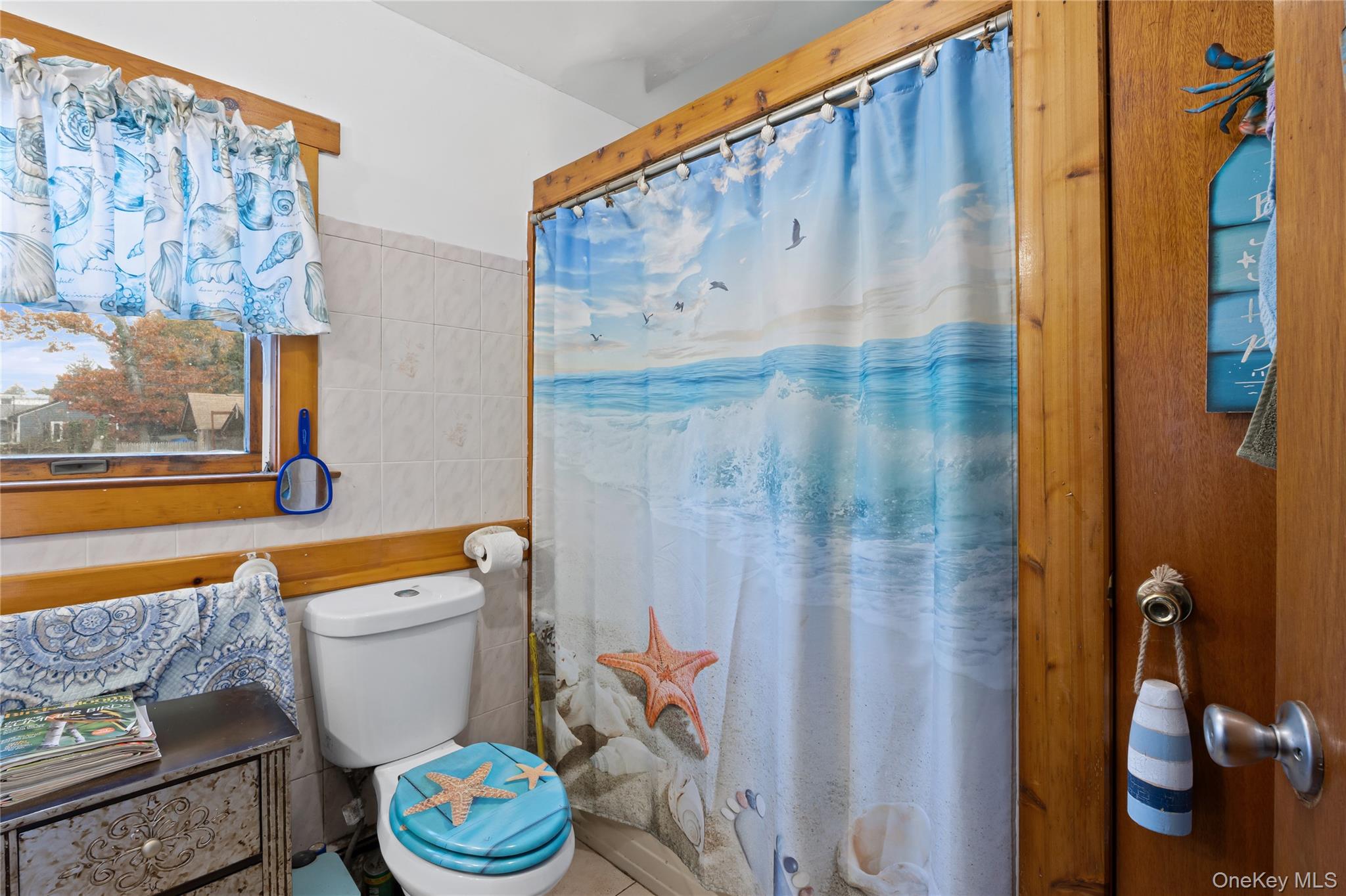 1 Elm Road East Mastic Beach, NY 11951 - Photo 20 of 28 a bathroom with a toilet and a shower curtain