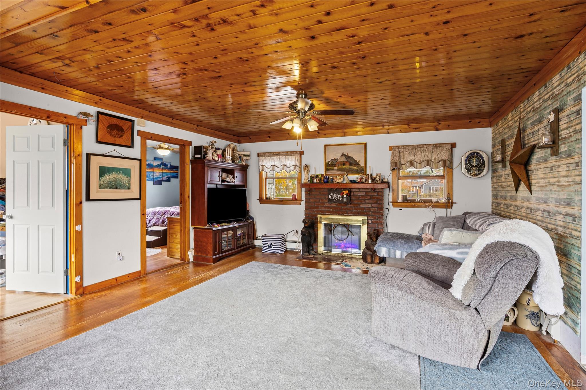 1 Elm Road East Mastic Beach, NY 11951 - Photo 9 of 28 a living room with furniture and a flat screen tv